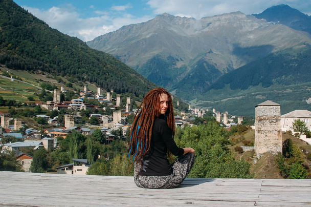 Hipster woman with dreadlocks travel along mountains and Svan to - Valokuva, kuva