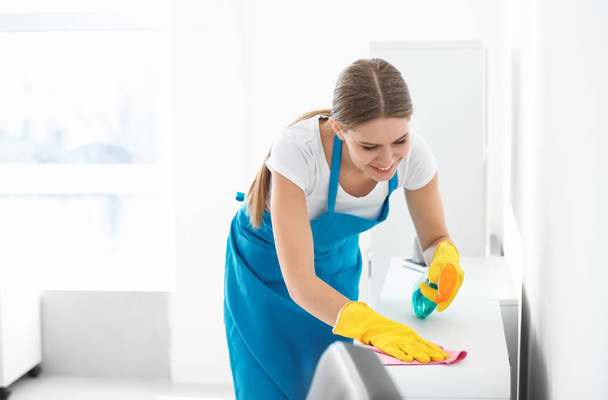 Female janitor cleaning office - Photo, Image