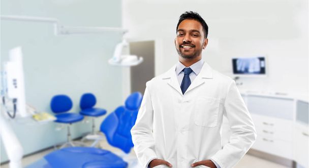 indian male dentist in white coat at dental clinic - Foto, immagini