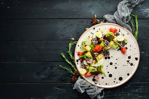 Vegetable salad with tuna and quail eggs. Top view. Free space for your text. - Foto, afbeelding