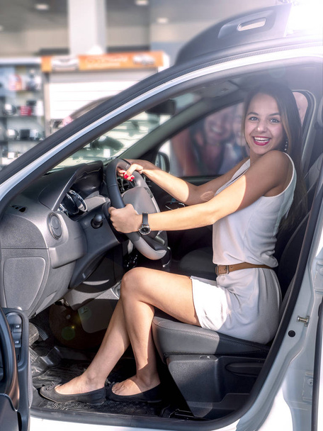 Woman buying the car. Lady in a car salon - Photo, image