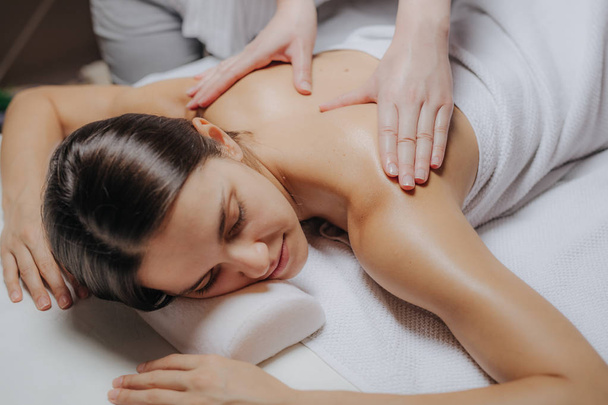 Woman Enjoying a Back Massage - Foto, immagini