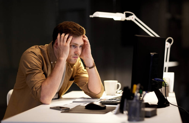 man with computer working late at night office - Φωτογραφία, εικόνα
