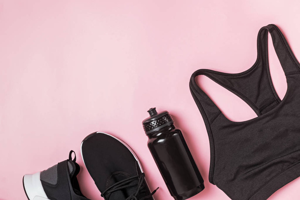 Black color fitness accessories set on pink background. - Foto, immagini