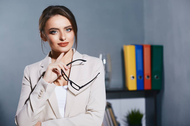 young businesswoman in suit in office - Fotó, kép