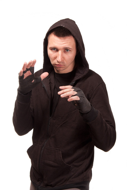 Young man in a hoodie standing in a fighting stance - Foto, imagen