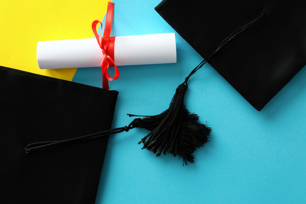 Mortaio tavole con diploma su sfondo colore. Concetto di diploma di scuola superiore
 - Foto, immagini