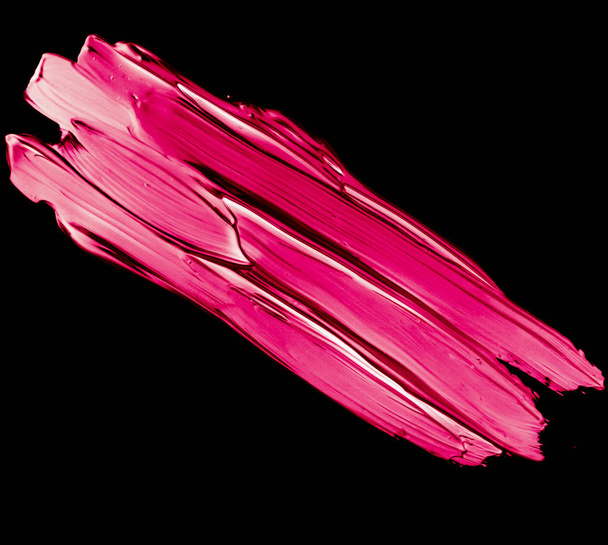 Pink lipstick brush stroke texture isolated on black background - Photo, Image