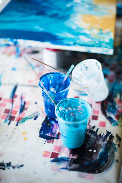 Palette of mixed paints in artists studio - Фото, изображение
