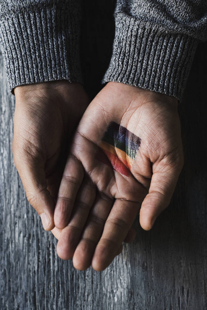 person with a rainbow flag in his or her hand - Foto, afbeelding