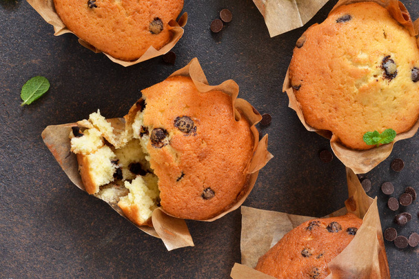Muffins with chocolate chunks on the kitchen table  - 写真・画像
