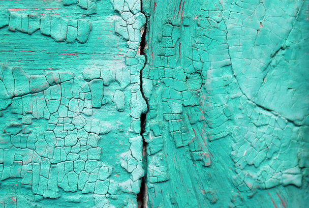 Old wooden background with remains of pieces of scraps of old paint on wood. Texture of an old tree, vintage wood background peeling paint. old blue board with cracked paint - Photo, Image