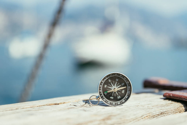 Sailing: nautical compass on wooden dock pier. Sailing boats in  - Valokuva, kuva