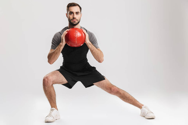 Confident motivated sportsman doing exercises - Zdjęcie, obraz