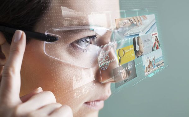 Woman in glasses with virtual screen - Photo, Image