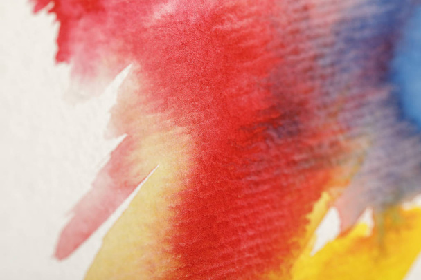close up view of multicolored watercolor paint spills on white background - Φωτογραφία, εικόνα