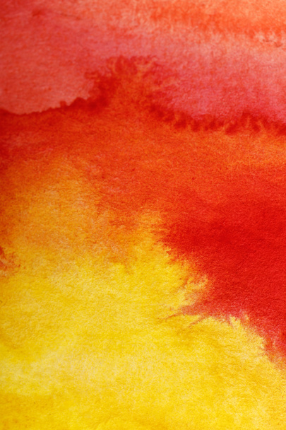 close up view of yellow and red watercolor bright paint spills  - Foto, Bild
