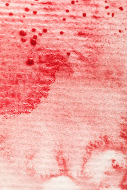 red watercolor paint spill on textured paper background - Fotoğraf, Görsel
