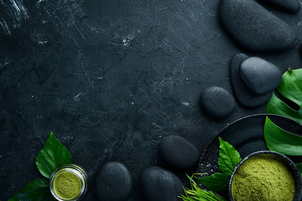 Zen stones and leaves with water drops. Spa background with spa accessories on a dark background. Top view. Free space for your text. - Fotoğraf, Görsel