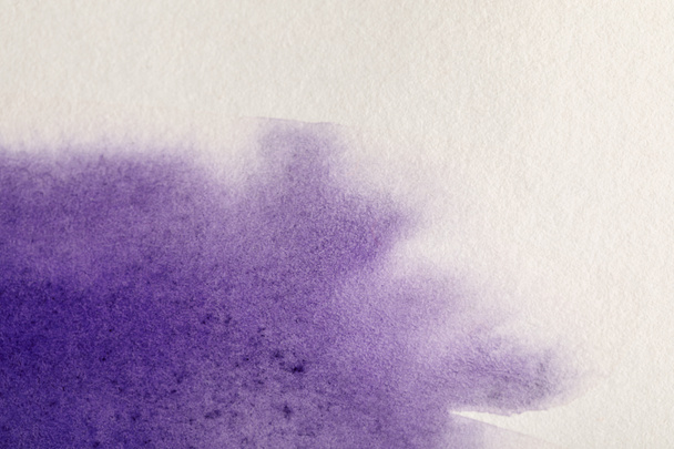 purple colorful watercolor paint spill on white textured background with copy space - Valokuva, kuva