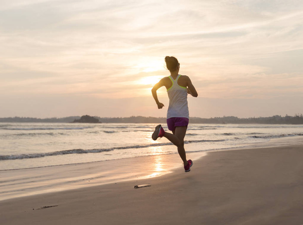 young fitness woman running at beach - Foto, Bild