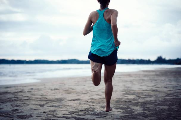  young fitness woman running at beach - 写真・画像