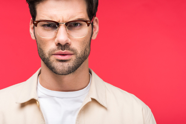 dissatisfied handsome man in glasses Isolated On pink - Foto, Bild