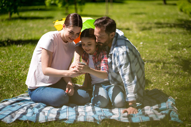 Happy family enjoying time in summer park - Zdjęcie, obraz