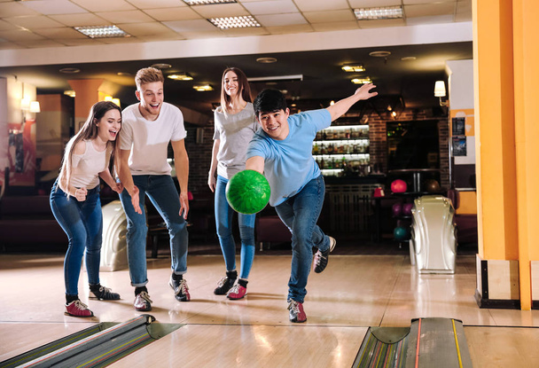 Friends playing bowling in club - Foto, Bild