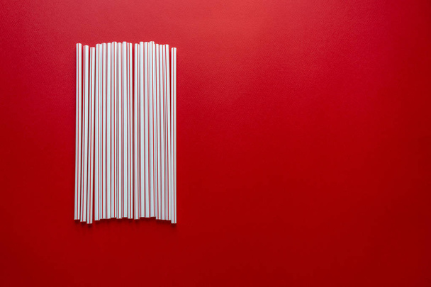 Colorful straw cocktail on red background - Photo, Image