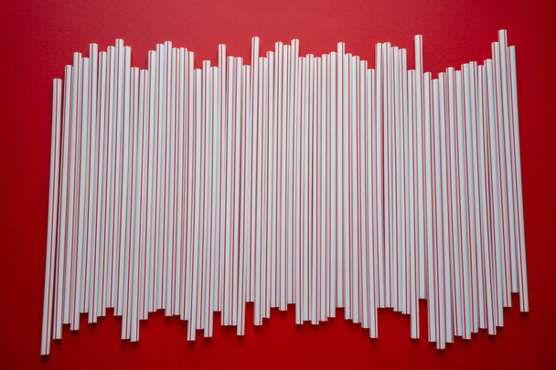 Colorful straw cocktail on red background - Photo, Image