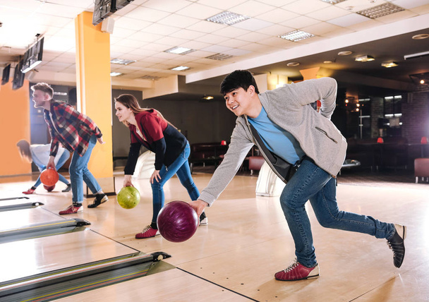 Friends playing bowling in club - Photo, Image