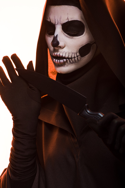 woman with skull makeup holding knife isolated on white - Photo, Image