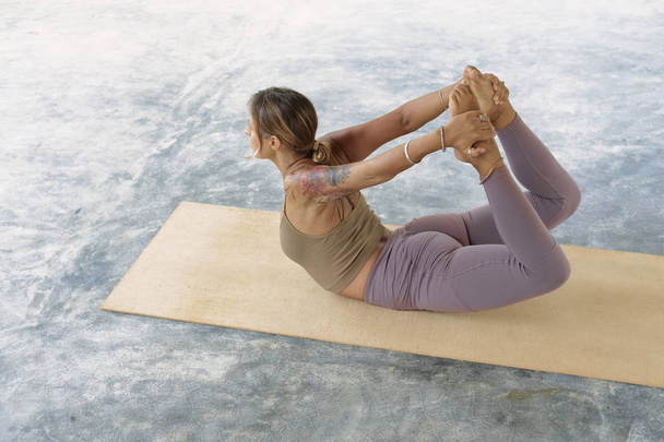 Woman Practicing Advanced Yoga on Organic Mat. Series of Yoga Poses. Tropical background - Valokuva, kuva