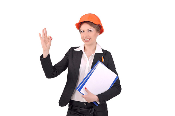 Girl in a construction helmet showing that all is well - Foto, Imagem