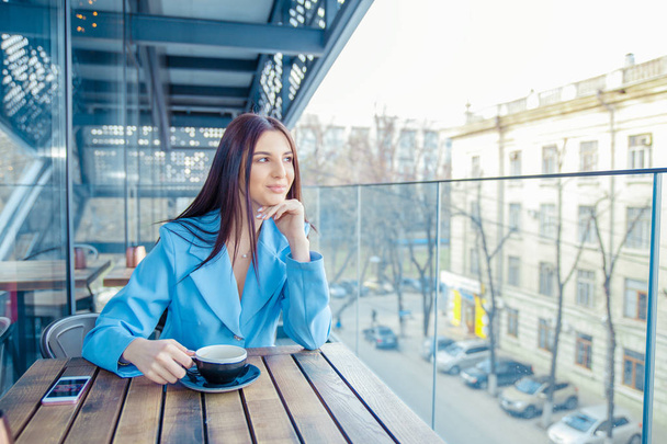 Thoughtful woman at trendy coffee shop - Foto, Imagem