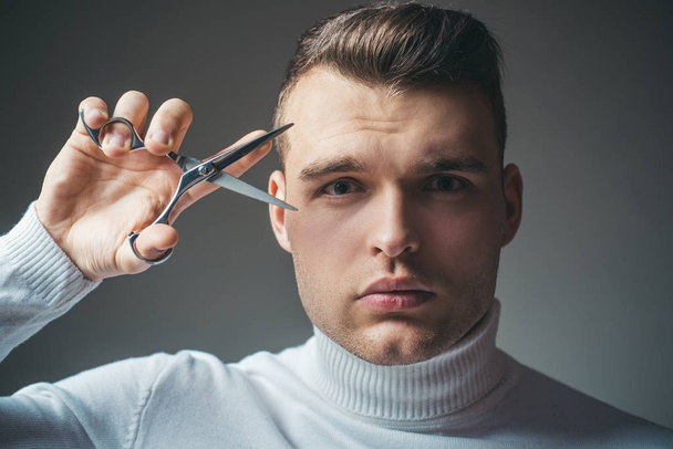 Barber glossy hairstyle hold steel scissors. Create your style. Macho confident barber cut hair. Barbershop service concept. Professional barber equipment. Cut hair. Man strict face hold scissors - Zdjęcie, obraz