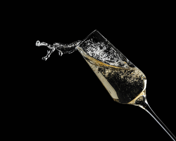 Glass of fizzy champagne on black background, closeup - Fotó, kép