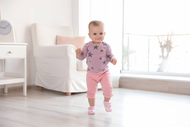 Cute baby girl walking in room at home - Fotografie, Obrázek