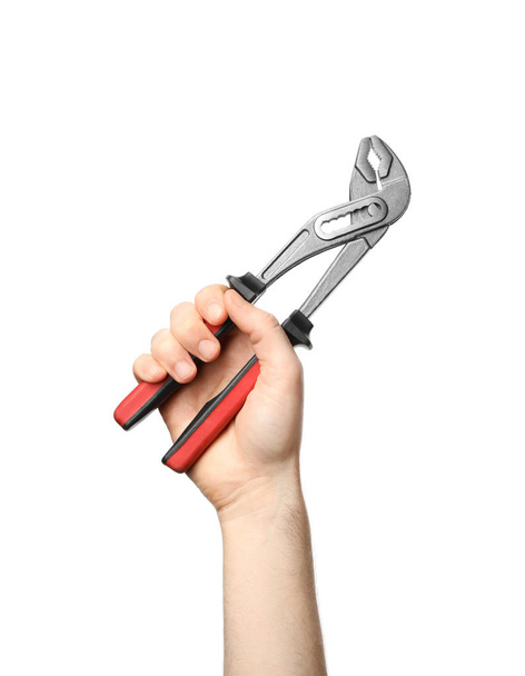 Man holding adjustable pliers isolated on white, closeup - 写真・画像