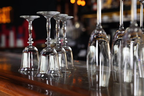 Different empty clean glasses on counter in bar - Photo, image
