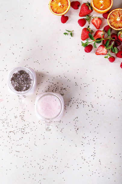 Strawberry smoothie in glass jars - Фото, изображение