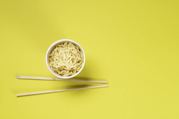 Cooked instant noodles with yellow background. - Photo, Image