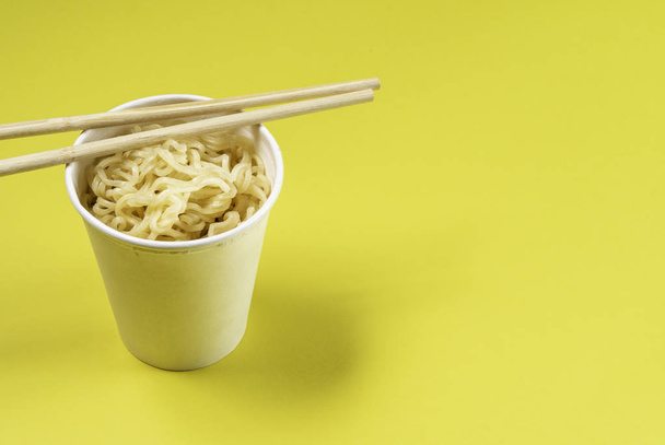 Cooked instant noodles with yellow background. - Photo, Image