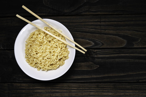 Soup Ramen noodles in ceramic bowl horizontal on a black background with copy space. - Photo, Image