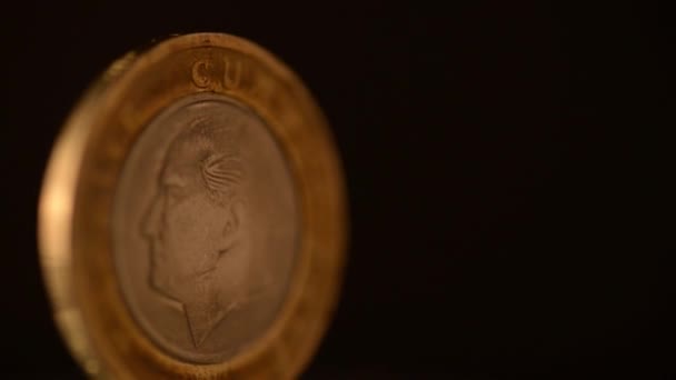 One Turkish Lira Coin is rotating on a black background. - Felvétel, videó