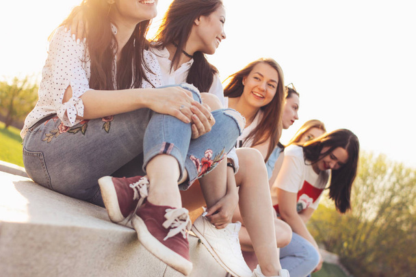 Skupina mladých šťastných dívek baví život na letních městských ulicích, pozadí slunce - Fotografie, Obrázek