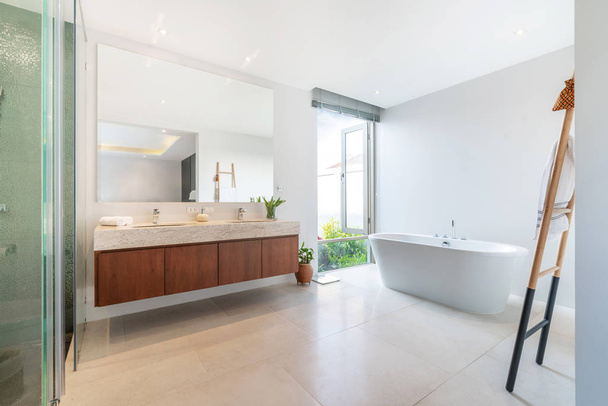 Luxury bathroom features basin and bathtub home, house, building
 - Фото, изображение