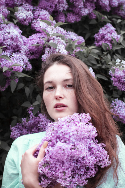 fashion photo of beautiful young woman surrounded by flowers. - Zdjęcie, obraz