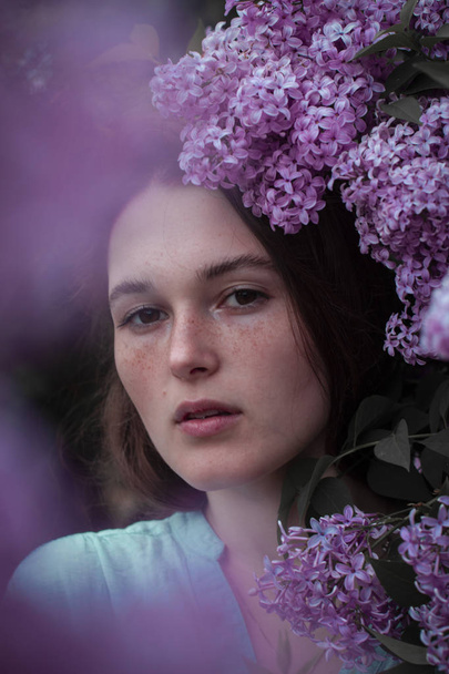 fashion photo of beautiful young woman surrounded by flowers. - Фото, изображение